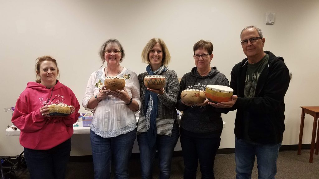 five people posing with their drums